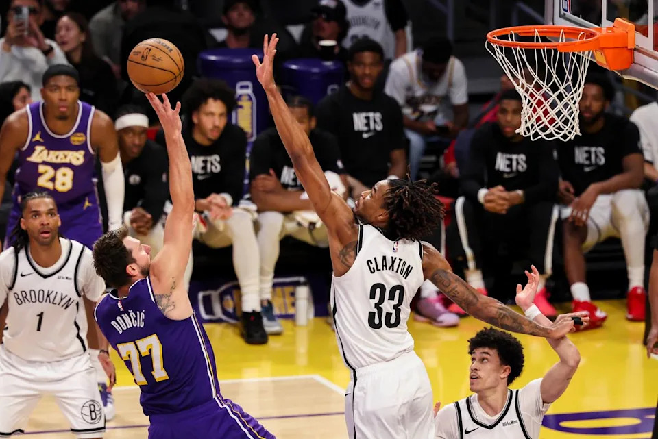 Luka Doncic #77 of the Los Angeles Lakers shoots the ball over Nic Claxton #33 of the Brooklyn Nets during an NBA basketball game, Friday March 27, 2026 in Los Angeles, Calif.