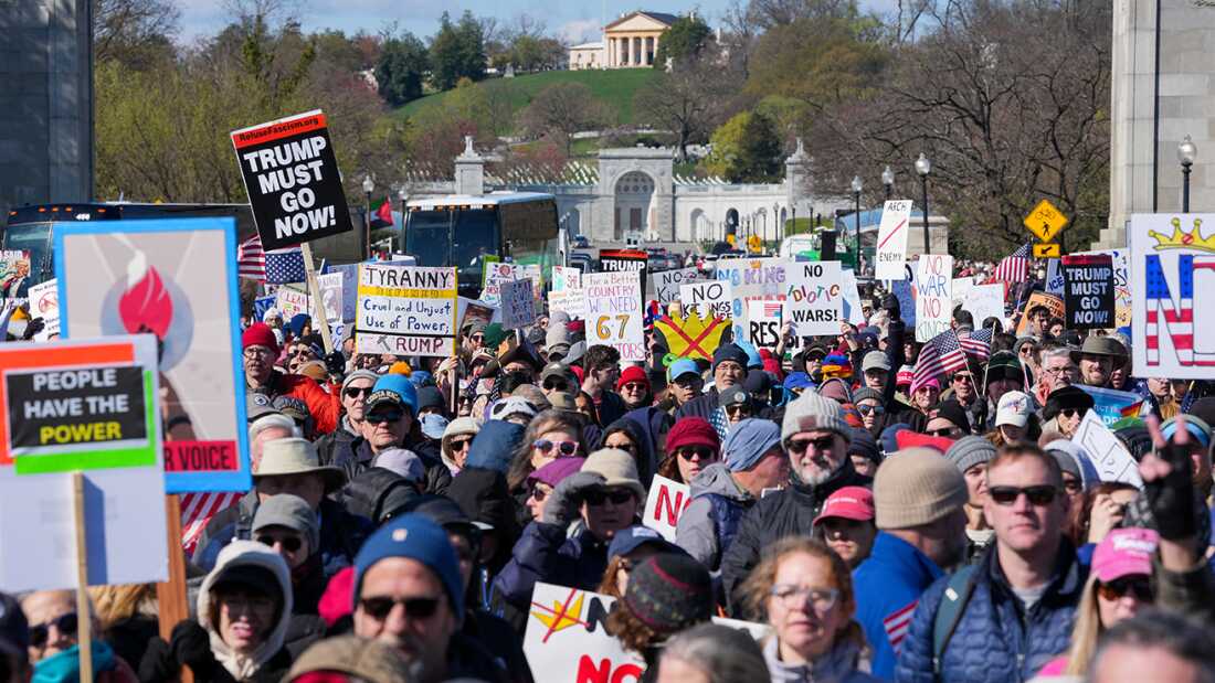 TOPSHOT - Demonstrators walk across the Memorial Bridge from Arlington, Virginia into Washington, DC, during the 