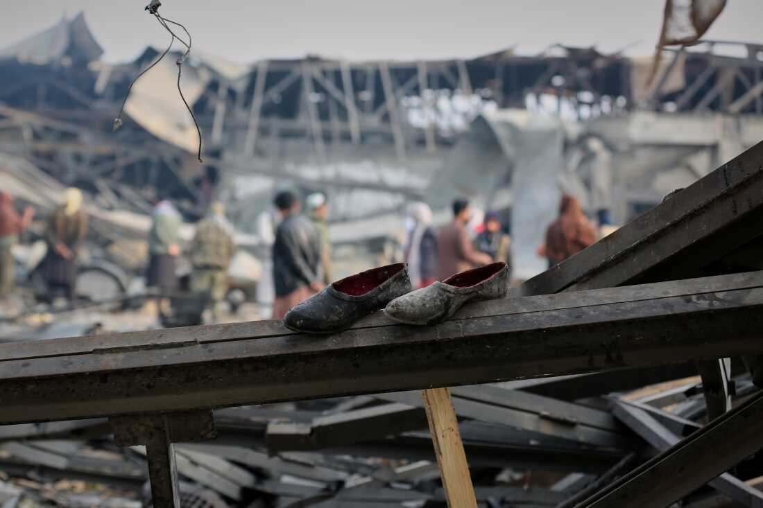 FILE - Residents and rescue workers inspect the site of an airstrike at a drug rehabilitation hospital in Kabul, Afghanistan, March 17, 2026.