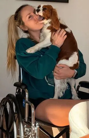 Lindsey Vonn cuddles with her dog while in a wheelchair in AprilCredit: Lindsey Vonn/Instagram