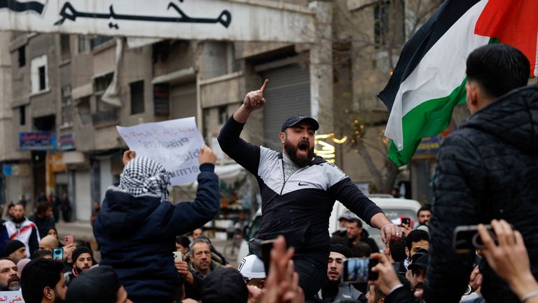 Protesters protest outside the entrance of Yarmouk refugee camp in Damascus. Pic: Reuters